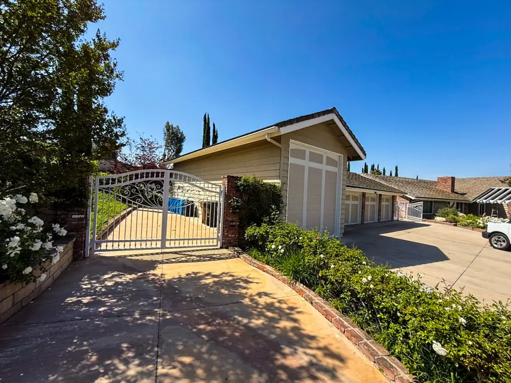 Entrance view of Yorba Linda property with driveway and garage exterior prior to painting.