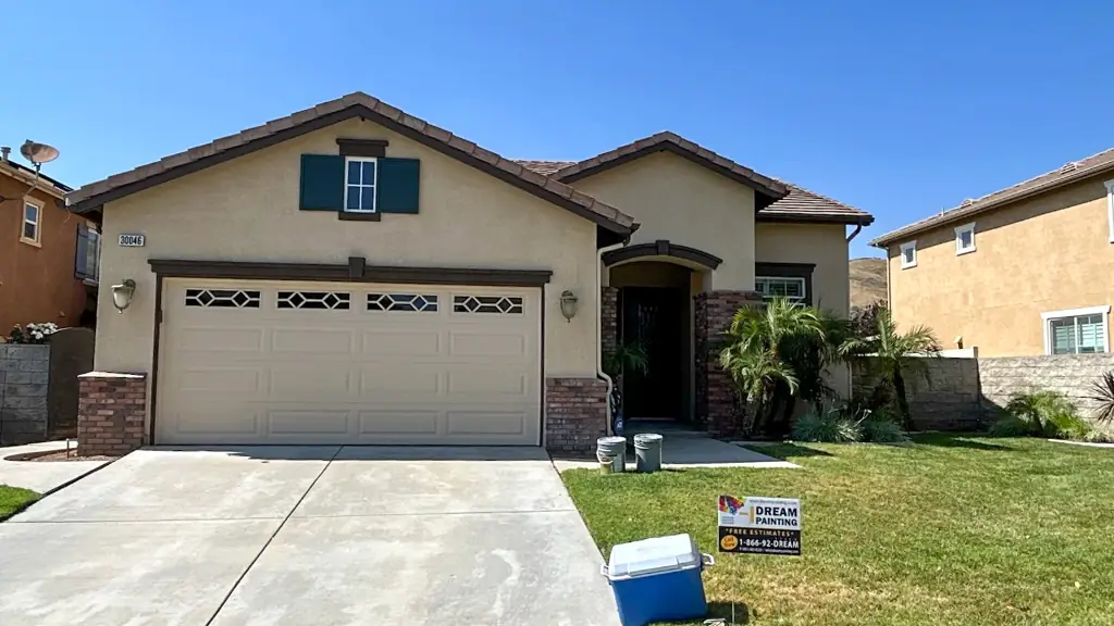 Professionally painted Highland home exterior showing smooth finish and architectural shutters from side angle