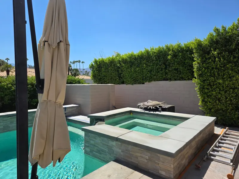 Beautifully repainted backyard spa and pool area at a residential property in Indian Wells, CA 92210, showcasing clean walls and a refreshed exterior finish.