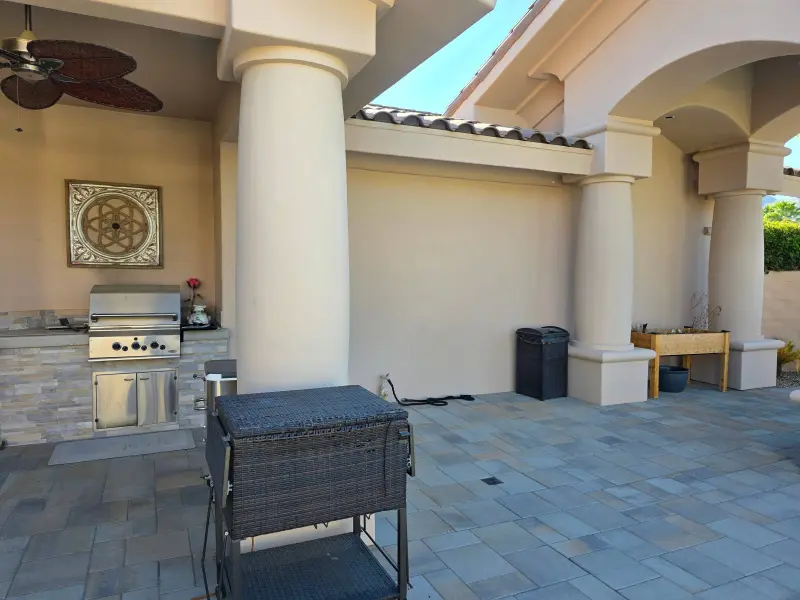 Freshly painted exterior walls and columns surrounding an outdoor kitchen and patio at a luxury residence in Indian Wells, CA 92210.